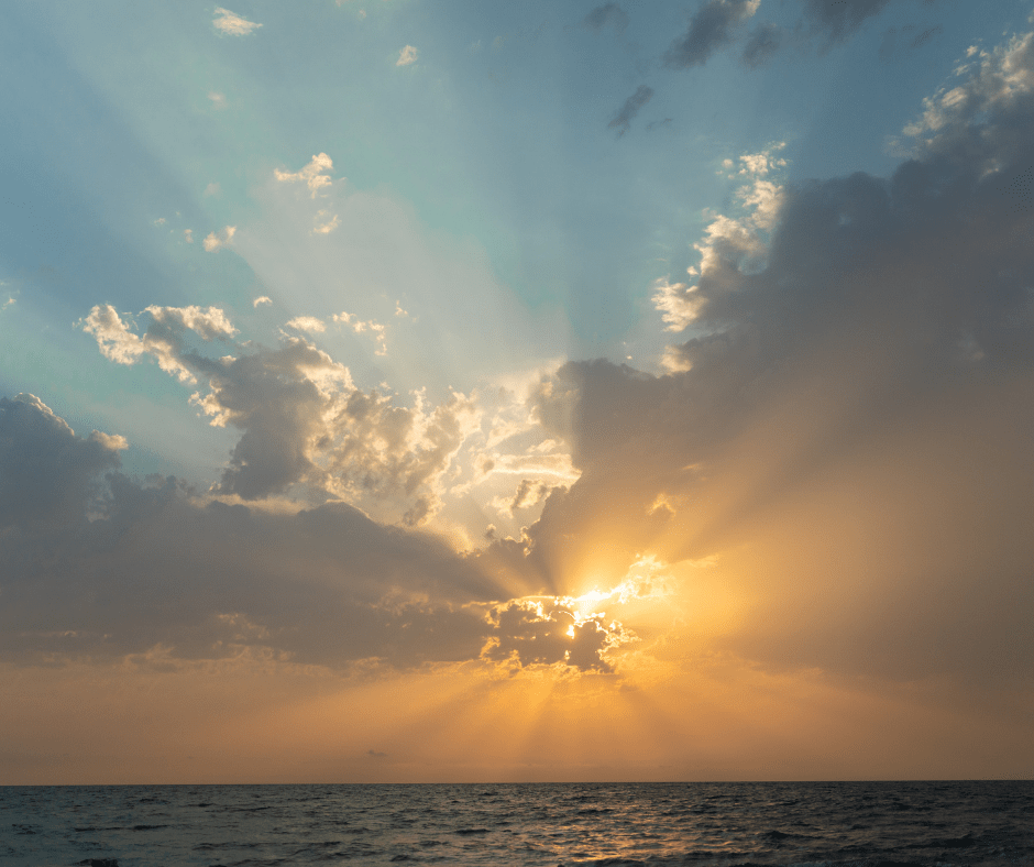 Canva sun shining through clouds over water