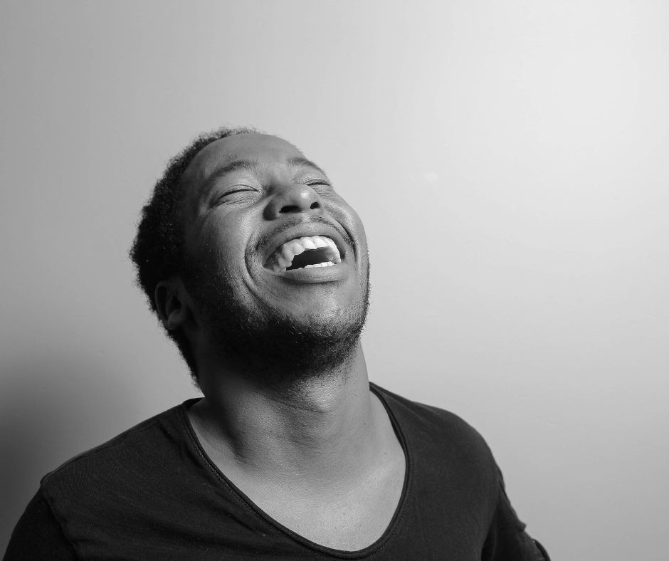 Grayscale Photograph of Man Laughing